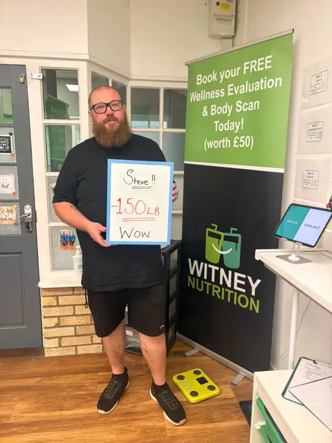 A club member holds up his assessment board at the club in Witney