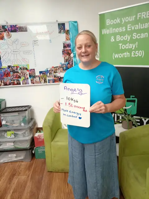 A club member holds up her assessment board at the club in Witney