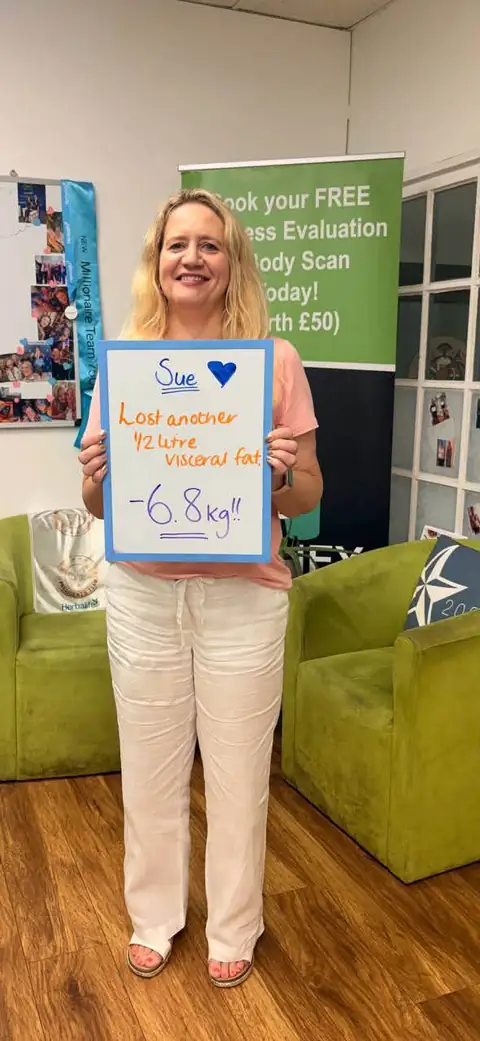 A club member holds up her assessment board at the club in Witney