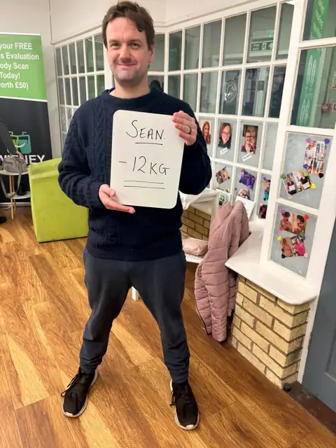 A club member holds up his assessment board at the club in Witney