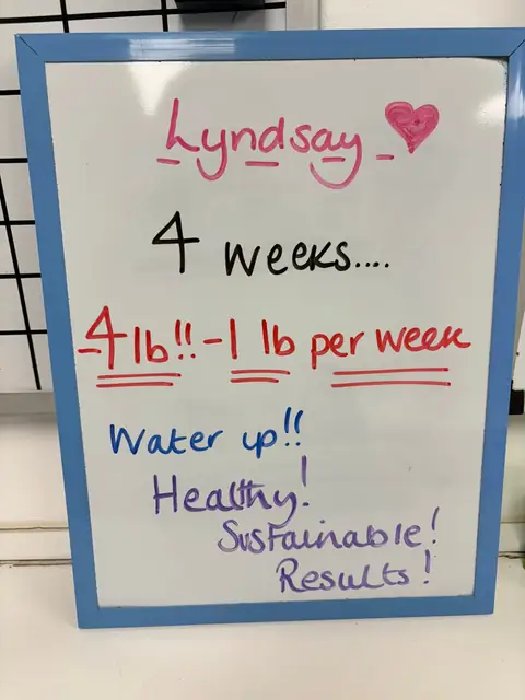 A club member holds up her assessment board at the club in Witney