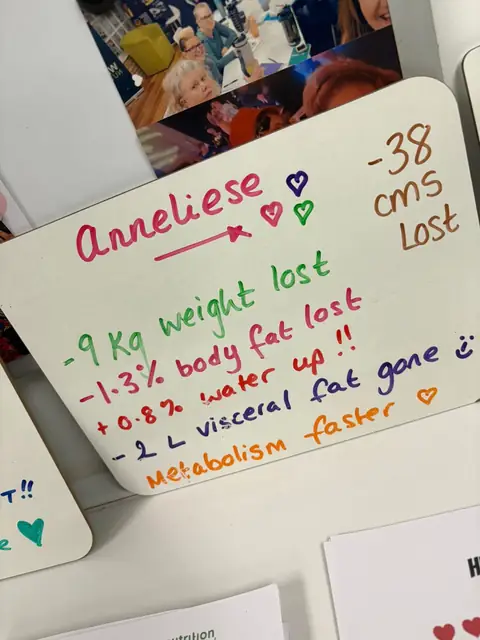 A club member holds up her assessment board at the club in Witney